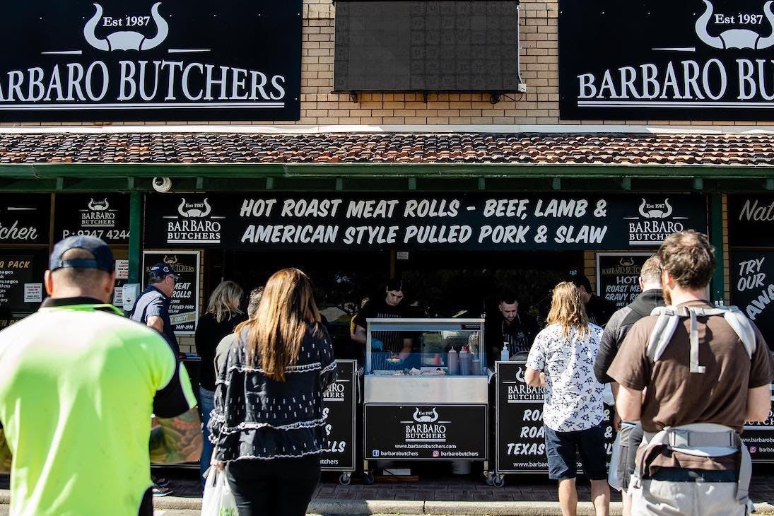 a butcher serving roast meat rolls in Perth